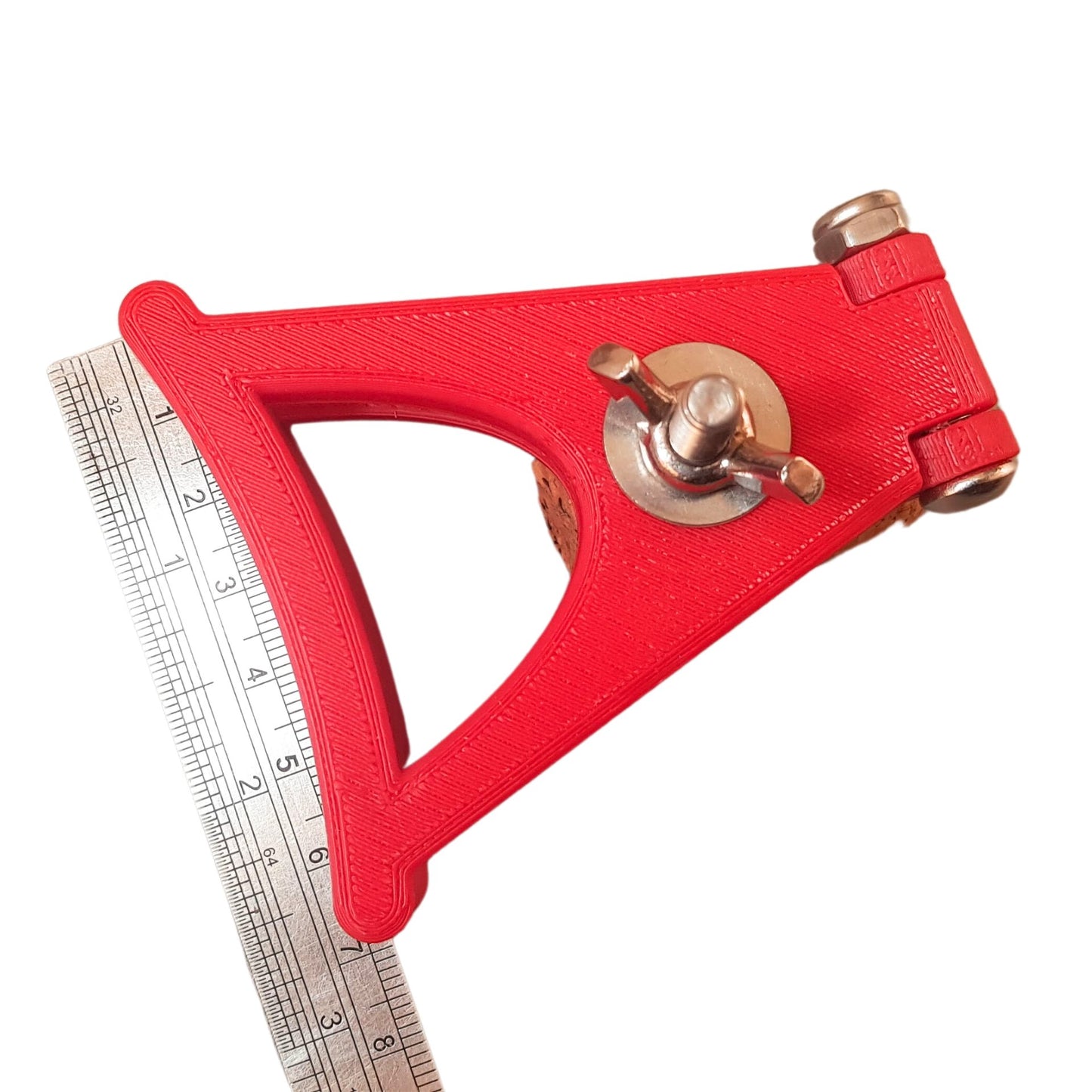 Red Labia Clamp shown with ruler for size reference
