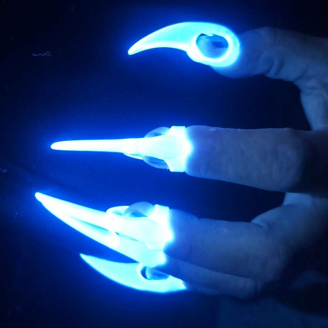 Crystal Claws for sensual couples play, lit up brilliantly by UV light in very dark room