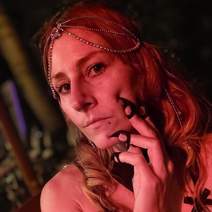 Person looking thoughtful while gently resting Stimming Claws on their face