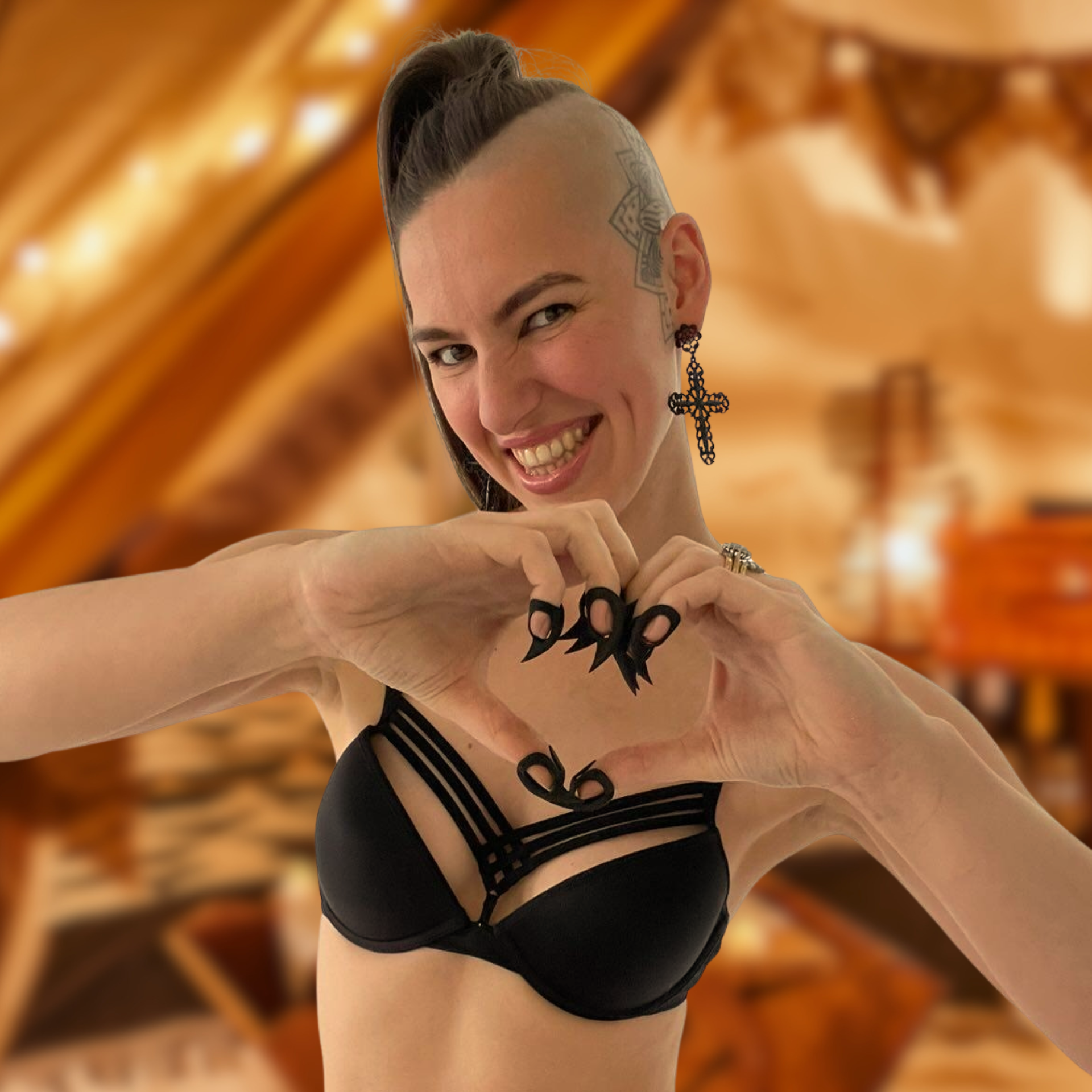 Young woman with a big smile wearing Stimming Claws for self-soothing while making a heart gesture