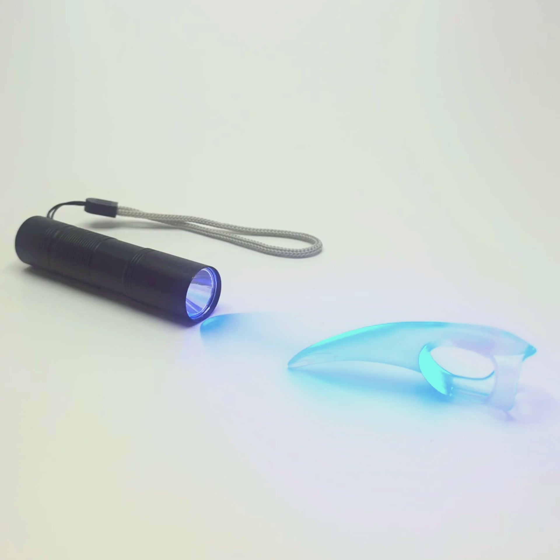 UV Torch lighting up UV reactive BDSM Claw. USB charging